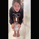 A pretty girl shits into a plastic container while squatting in a bath tub. Action is a little bit off-center, but still visible. Vertical HD format video. About a minute.
